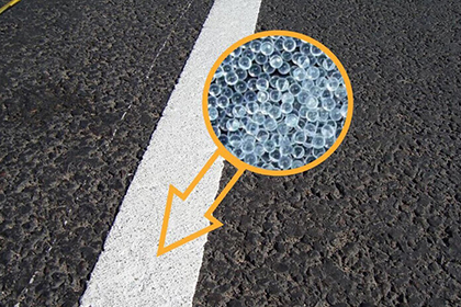 Glass beads in road marking paint